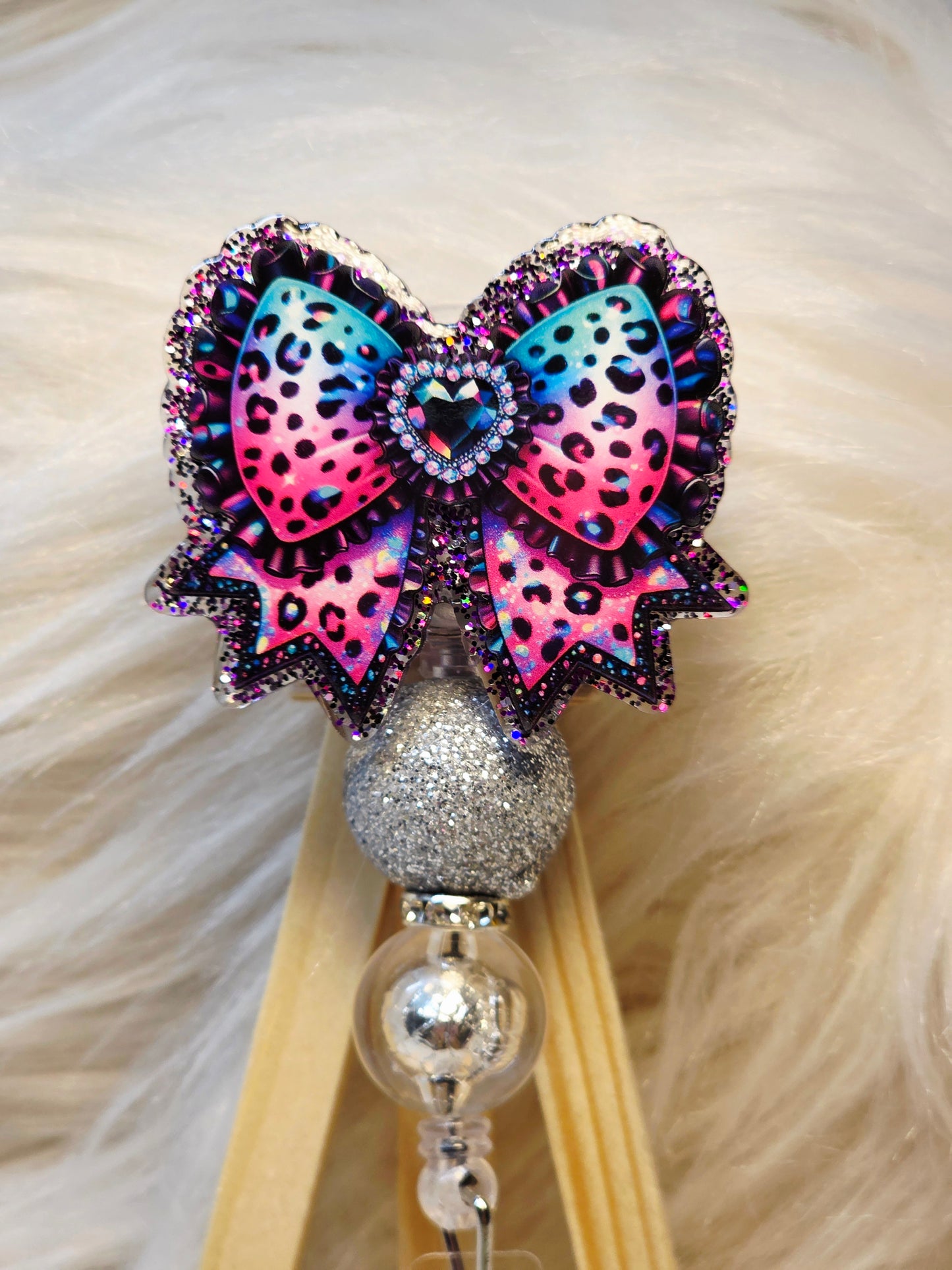 Bright Cheetah Bow Badge Reel Face