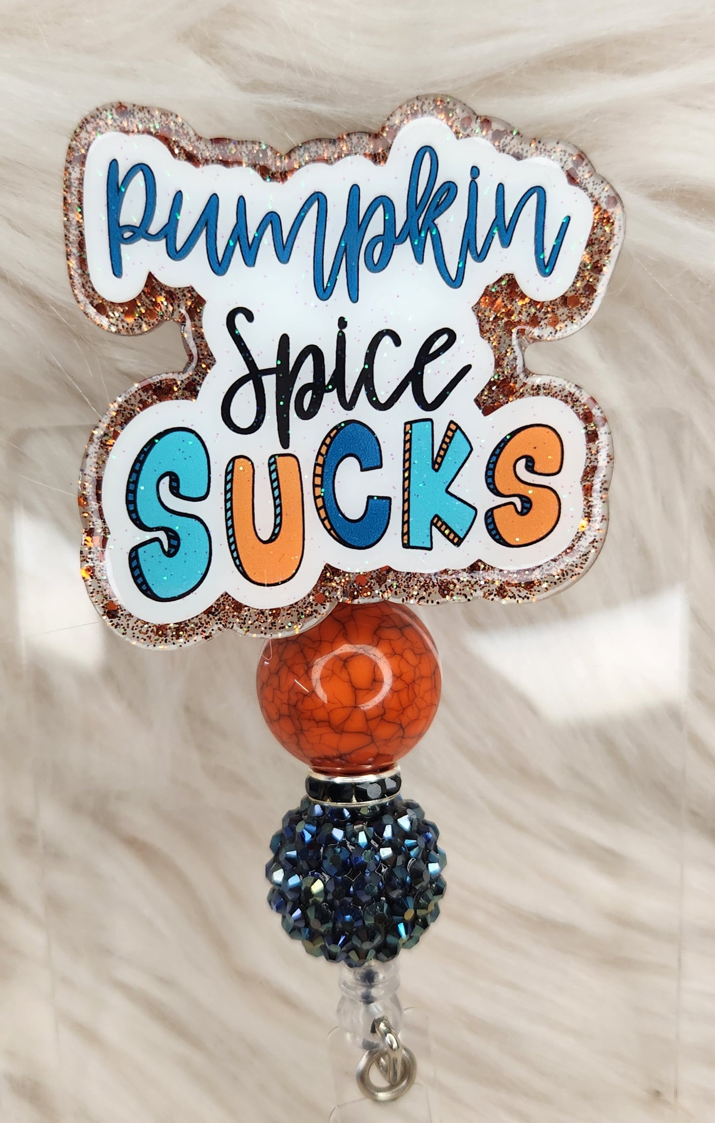 Pumpkin Spice Sucks Badge Reel Face