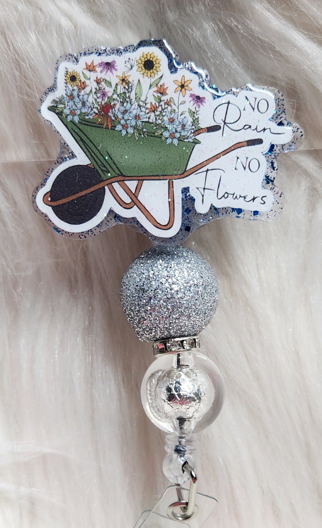 No Rain No Flowers Badge Reel Face