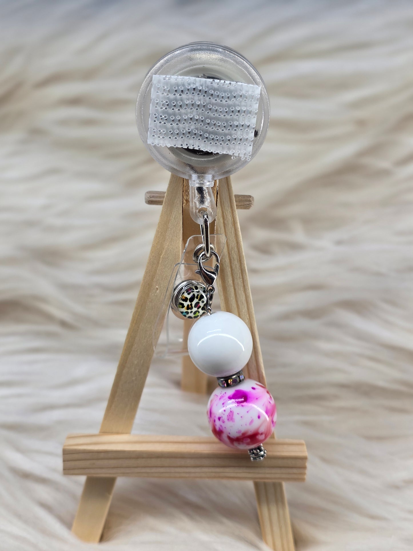 Pink/Red Splatter Badge Reel Charm