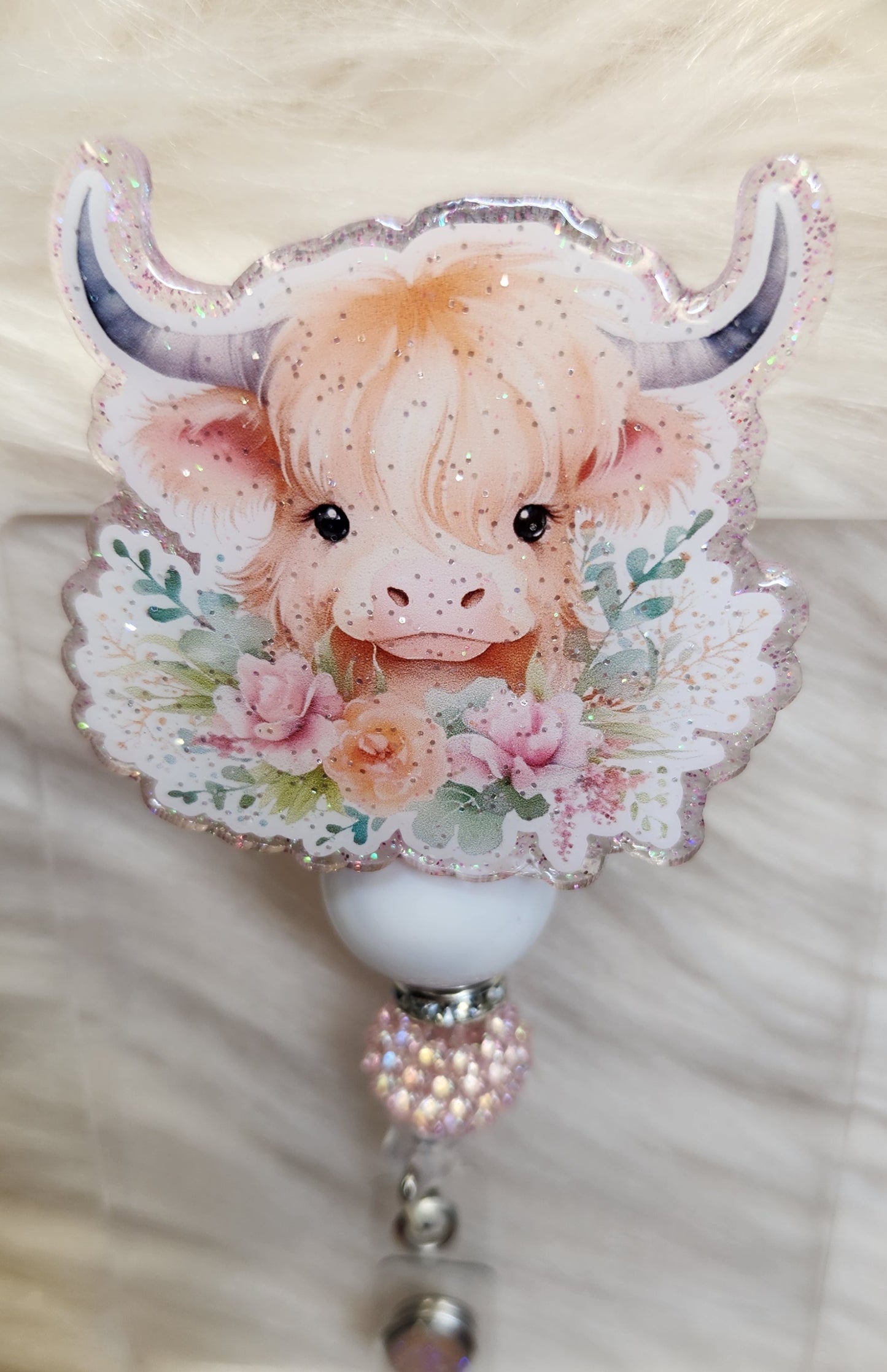 Cow and Flowers Badge Reel Face