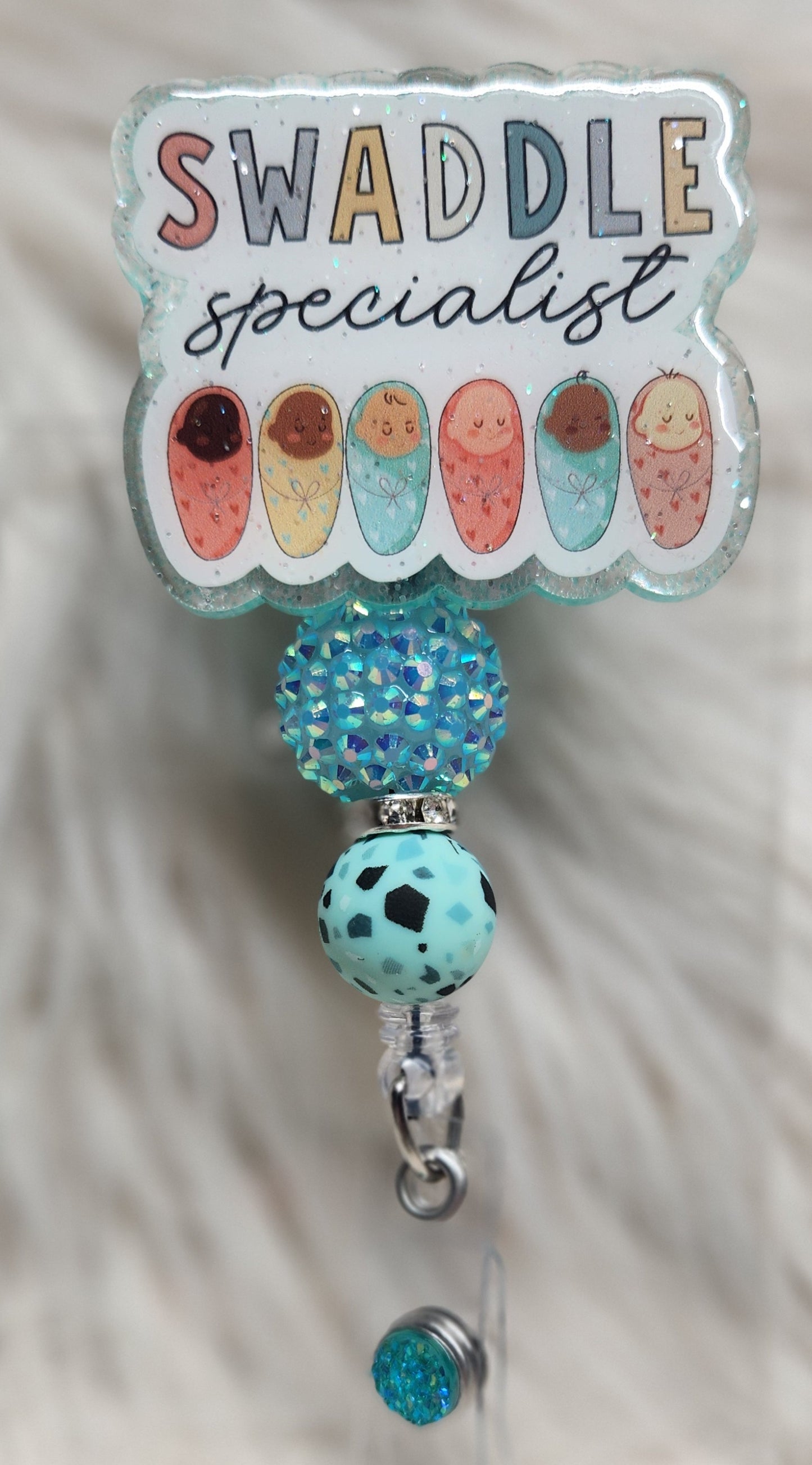 Swaddle Specialist Badge Reel Face