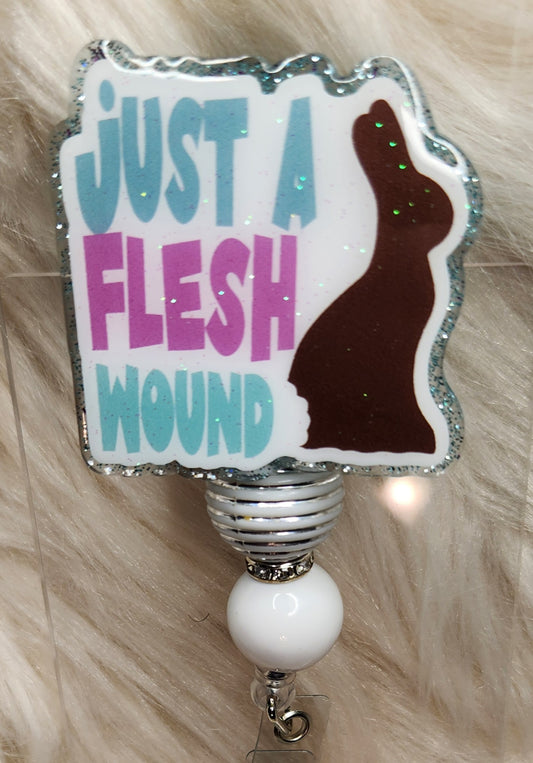 Flesh Wound Badge Reel Face